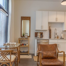 living area with a table and chairs next to a window